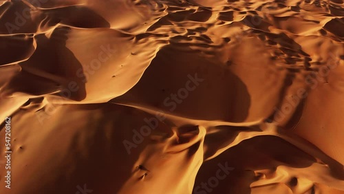 Desert sand dunes aerial top view. Wavy golden surface of desert nature