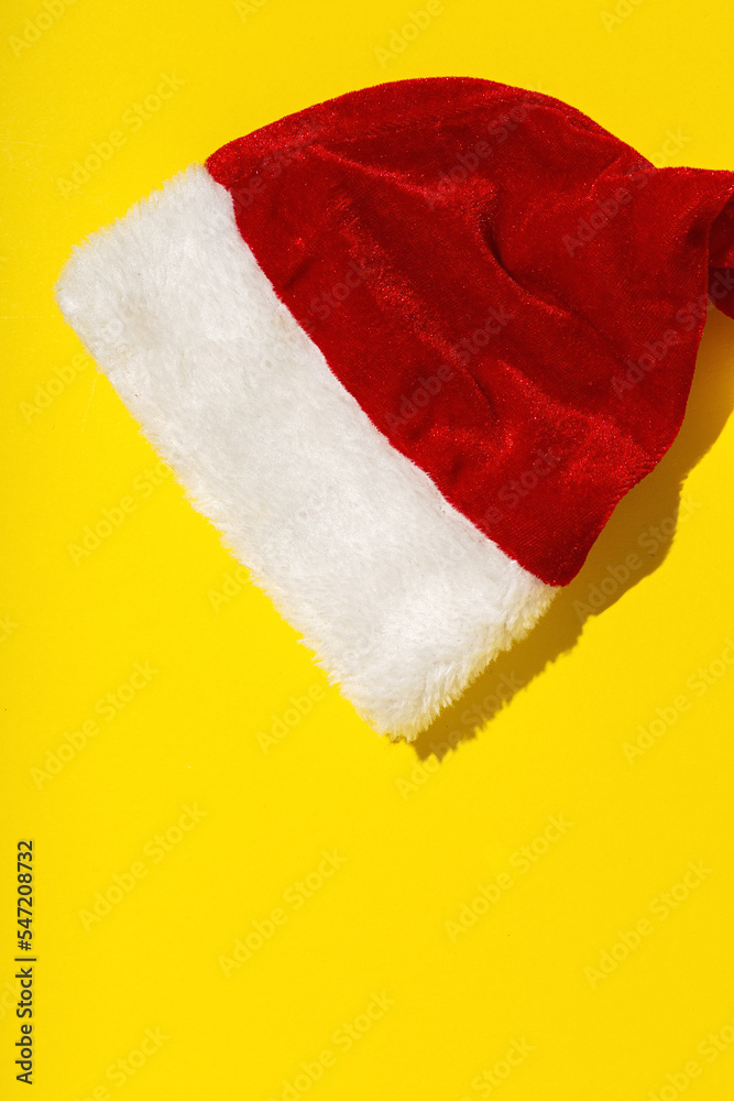 Santa Claus red hat isolated from above on colorful background Santa Claus red hat isolated from above on colorful background
