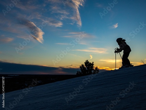 silhouette of a person skiing at sunset