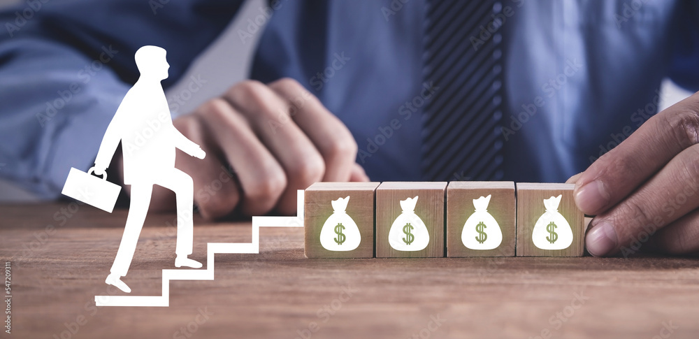 Businessman walking up to money bag. Businessman walking up to money bag.