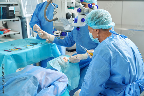 Two doctors doing laser vision correction in hospital