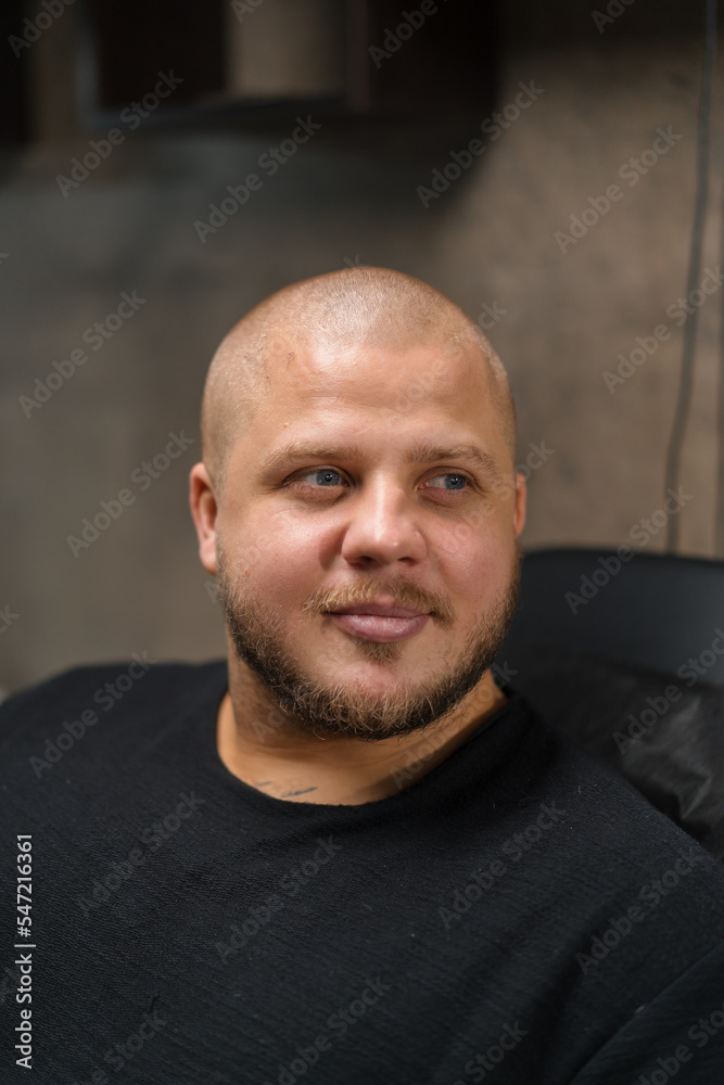 Fototapeta premium Close-up - pensive face of a man in the interior of a renovation loft