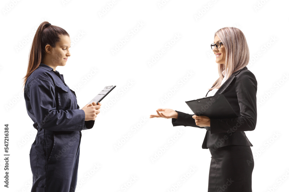 Profile shot of a businesswoman talking to a female auto mechanic