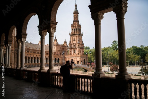 Photographer standing on the balcony with a view of the Plaza de Espana.