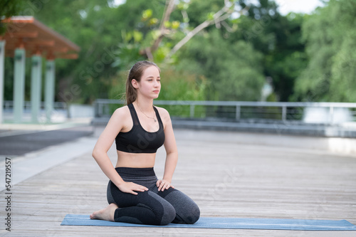 Caucasian women roll yoga mat for yoga training at park outdoor