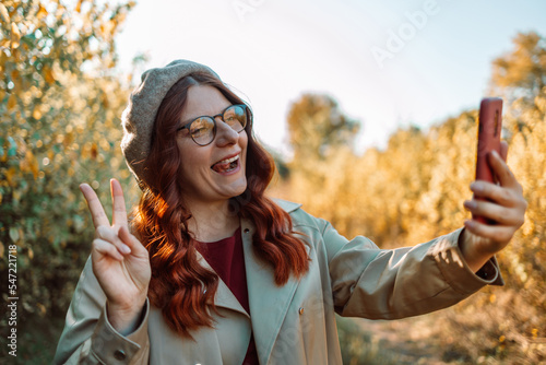 Self-portrait of her she nice attractive pretty trendy positive funky cheerful cheery girl spending weekend free time traveling October showing v-sign having fun. 