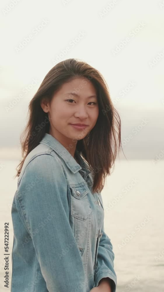 VERTICAL VIDEO: Beautiful young woman posing on seascape VERTICAL VIDEO: Beautiful young woman posing on seascape