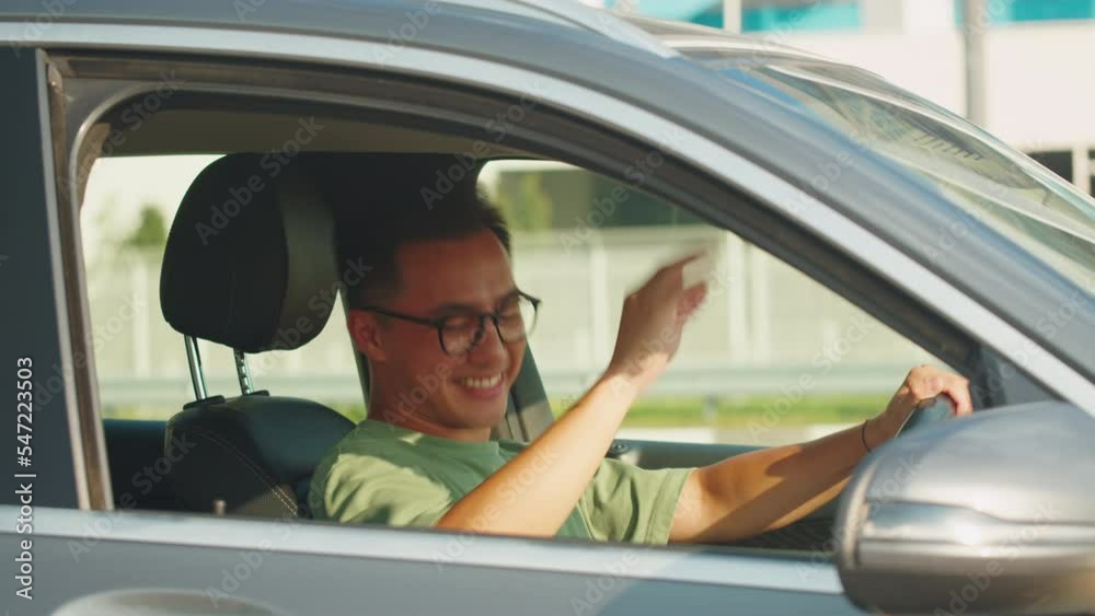 Young asian man driver in car, sharing concept, vehicle and premium transport. Korean happy guy driving, sitting in new luxury car and smiling. Traveling by automobile. Young asian man driver in car, sharing concept, vehicle and premium transport. Korean happy guy driving, sitting in new luxury car and smiling. Traveling by automobile.