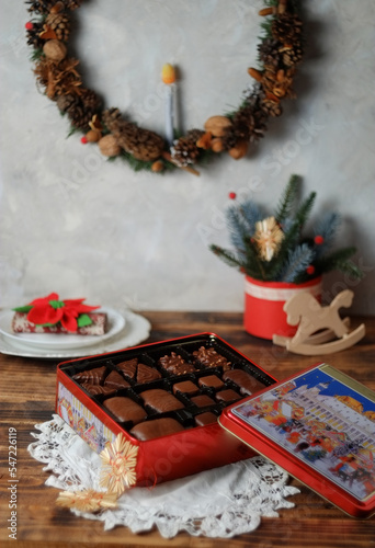 Winter festive composition on a wooden table with Christmas gift box with chocolate sweets. Nuremberg gingerbread german sweetness for christmas