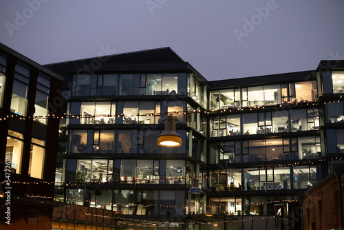 Office building at night. Silhouettes of office workers. Christmas is coming. © Ivan