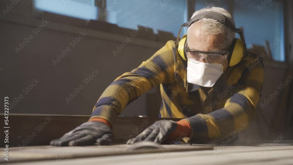 Adult carpenter cuts wood with a table saw.
Wood cutting. The carpenter is chopping wood.
Adult carpenter cuts wood with a table saw.
Wood cutting. The carpenter is chopping wood.