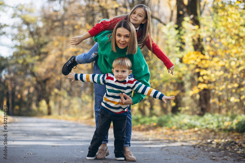 Fototapeta premium Mother with children walking in park
