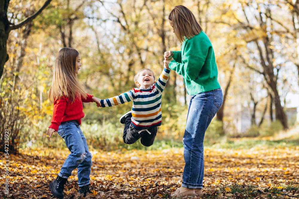 Fototapeta premium Mother with children walking in park