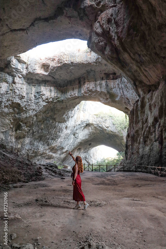 A woman wandering in the stunning Devetshka cave in Bulgaria. photo