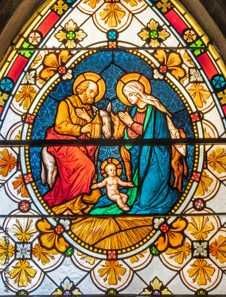 BIELLA, ITALY - JULY 15, 2022: The Holy Family in the stained glass of Duomo from 19. cent.