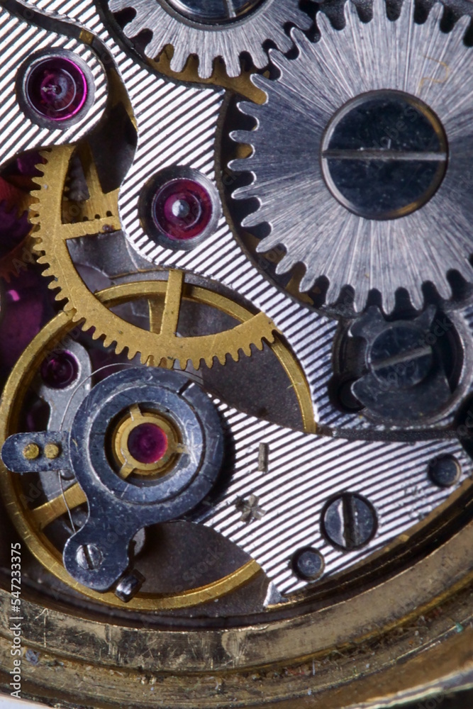 Close view of a watch mechanical wristwatch mechanism with wheels and ruby stones