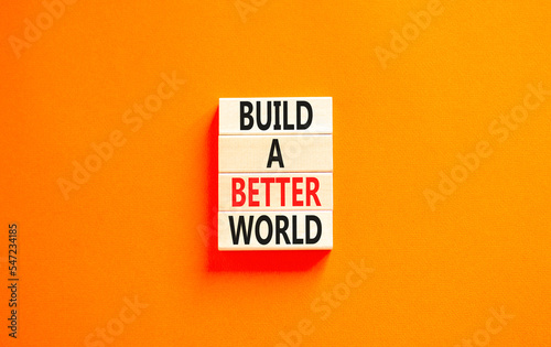 Build a better world symbol. Concept words Build a better world on wooden cubes. Beautiful orange table orange background. Business build a better world concept. Copy space.