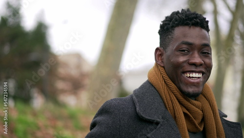 Happy black African man looking at camera smiling portrait during winter season3