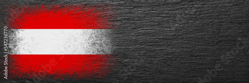 Flag of Austria. Flag is painted on black slate stone. Stone background. Copy space. Textured background