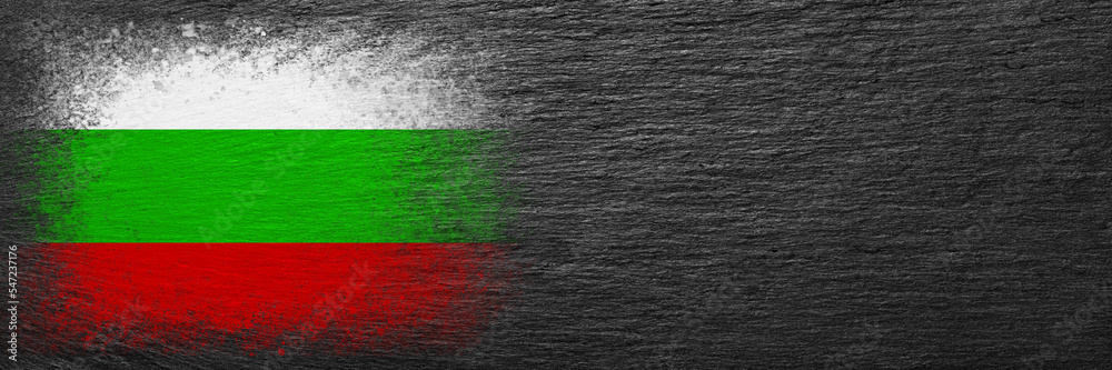 Flag of Bulgaria. Flag is painted on black slate stone. Stone background. Copy space. Textured background Flag of Bulgaria. Flag is painted on black slate stone. Stone background. Copy space. Textured background