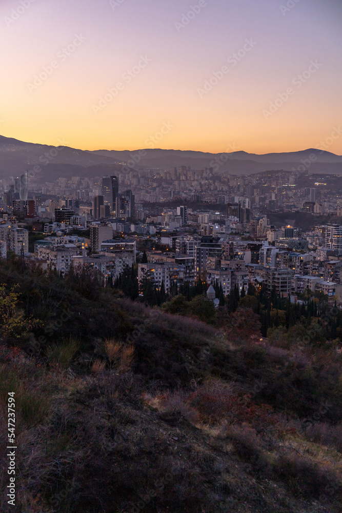 view of a large modern city among the mountains at dusk. Tbilisi. Georgia