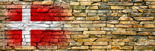 Flag of Denmark. Flag is painted on a stone wall. Stone background. Copy space. Textured background