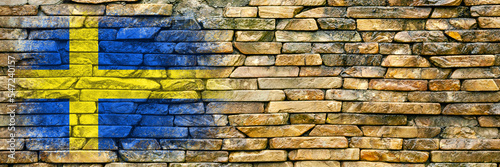 Flag of Sweden. Flag is painted on a stone wall. Stone background. Copy space. Textured background