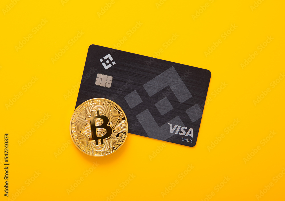 LONDON,UK - NOVEMBER 19, 2022: Binance visa credit card with bitcoin on  yellow background. Cryptocurrency platform for trading and exchange. Stock  Photo | Adobe Stock