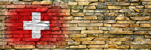 Flag of Switzerland. Flag is painted on a stone wall. Stone background. Copy space. Textured background