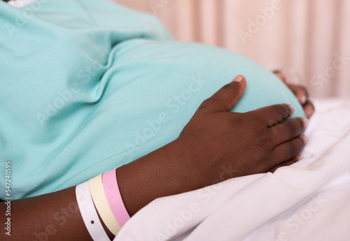 A pregnant woman in labor, lying in a hospital bed waiting for her baby to be born.