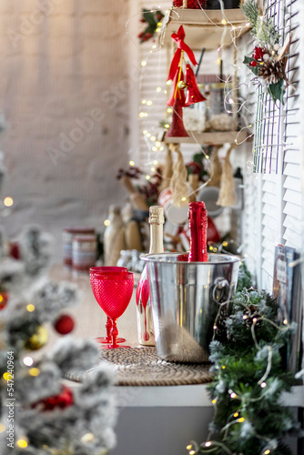Champagne bottles and glasses on the table against the backdrop of Christmas decorations
