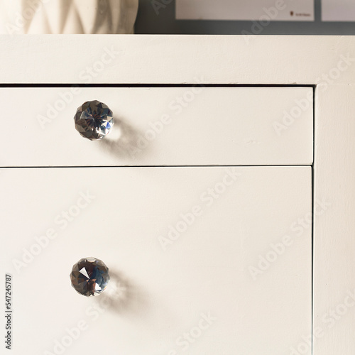 Front view of white drawers of a decorative furniture for you bedroom or living room