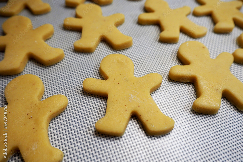 raw gingerbread lies on a silicone oven mat. gluten free. side view raw gingerbread lies on a silicone oven mat. gluten free. side view