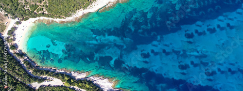 Aerial drone ultra wide panoramic photo of tropical Caribbean island bay with white sand beach and beautiful turquoise and sapphire clear sea forming a blue lagoon