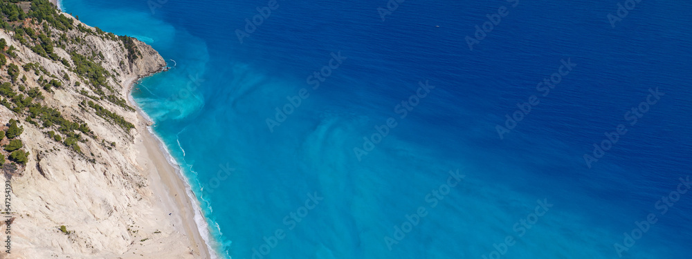 Aerial drone photo of famous paradise beach of Egremni white steep rocky hills overlooking deep turquoise Ionian sea, Lefkada island
