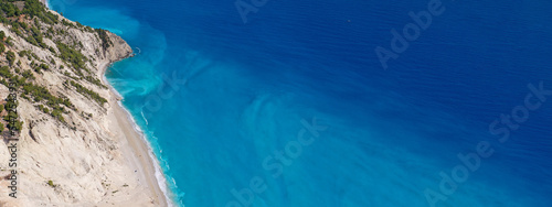 Aerial drone photo of famous paradise beach of Egremni white steep rocky hills overlooking deep turquoise Ionian sea, Lefkada island