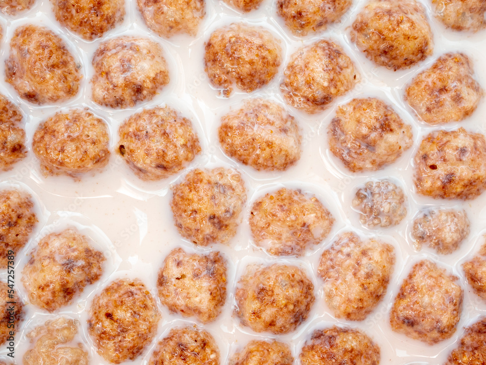 Top view of corn flakes floating in milk close up. Quick tasty and healthy breakfast. Flat layout. Top view of corn flakes floating in milk close up. Quick tasty and healthy breakfast. Flat layout.