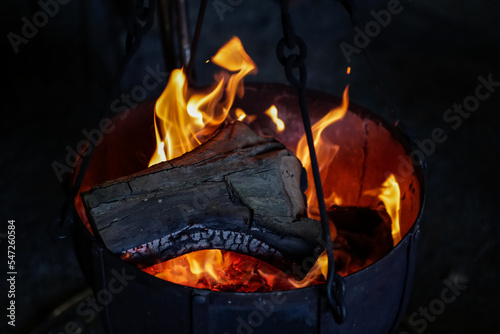 bonfire on fire to warm up from the cold in winter, in a copper pot