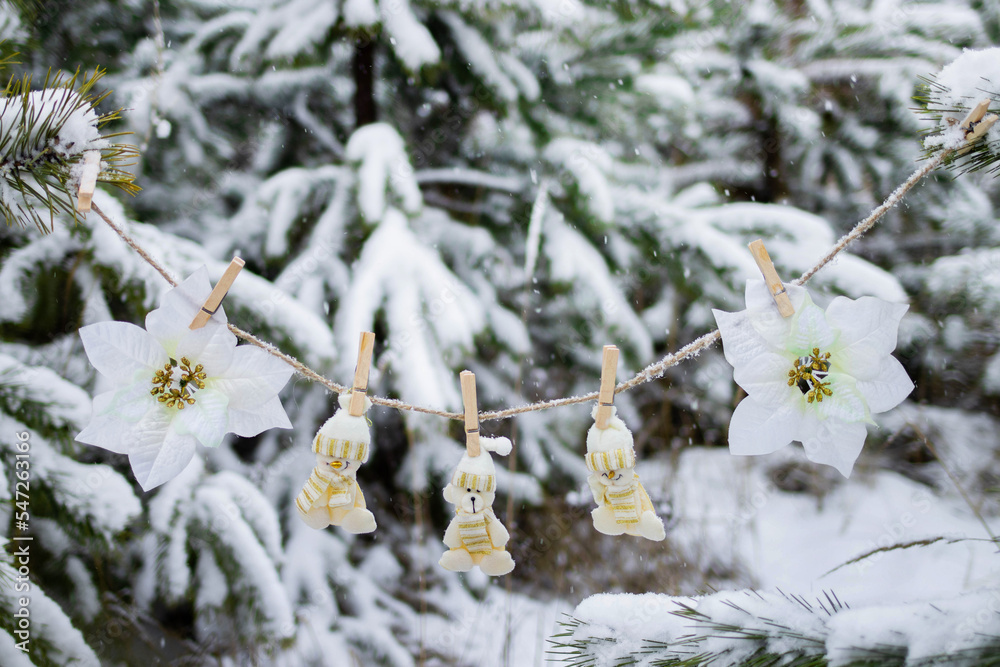 New Year's decoration on a Christmas tree in a winter forest during snowfall. The atmosphere of Christmas and New Year