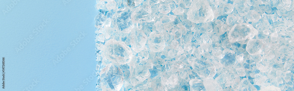 Close up crushed ice in sunlight on blue with copy space. Summer background refreshment concept Close up crushed ice in sunlight on blue with copy space. Summer background refreshment concept