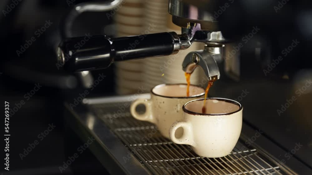 Slow-motion video of espresso pouring with a coffee machine in a cafe. Close-up of how coffee flows into a cup. Cappuccino preparation by a barista in a cafe. High quality 4k footage Slow-motion video of espresso pouring with a coffee machine in a cafe. Close-up of how coffee flows into a cup. Cappuccino preparation by a barista in a cafe. High quality 4k footage