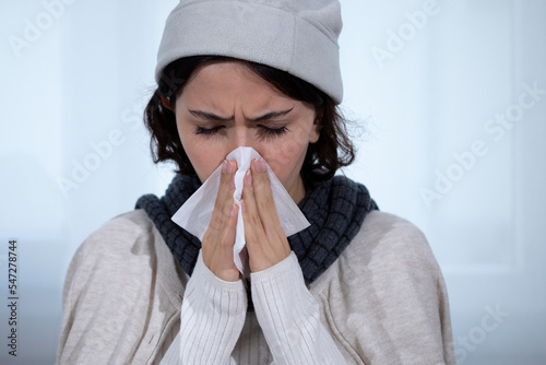 young woman got flue sneezing to paper