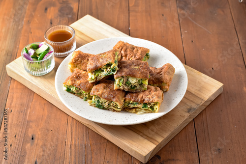 Photography Indonesian Street Food Martabak Telur, Savory pan-fried pastry stuffed with egg, meat, green onion and spices