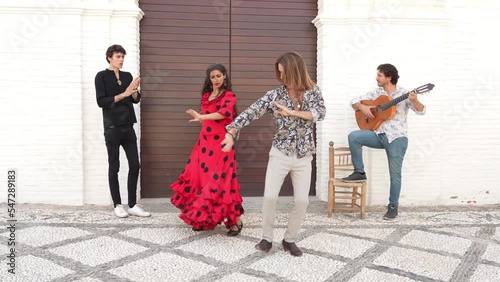 Multiethnic group of flamenco dancers dancing for tourists in San Nicolas. Albaicin.