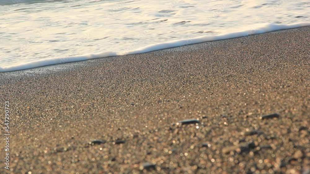 Black Sand Shore with calm ripples on santorini island close-up 4 with morning sun Black Sand Shore with calm ripples on santorini island close-up 4 with morning sun