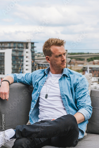 A young man sitting on a bench