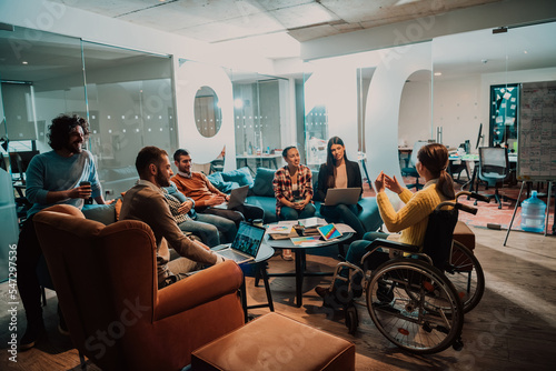 Fotobehang Businesswoman in wheelchair having business meeting with team at modern office