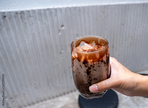 dirty coffee on hand with concrete background