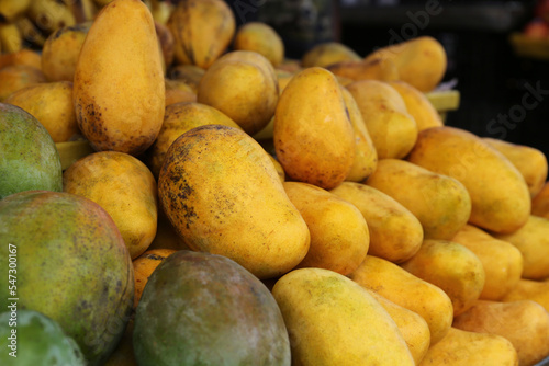 Pile of delicious ripe yellow mangoes  closeup