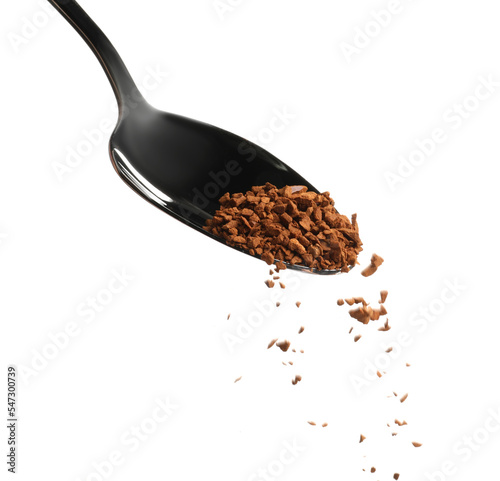 Pouring aromatic instant coffee from spoon on white background